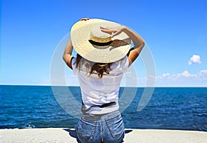 Young happy blond woman at beautiful tropical paradise view of ocean enjoying summer holidays