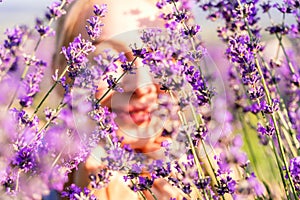 Young and happy blonde woman posing in the lavender field garden,