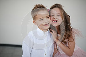 Young happy boy and girl together outside