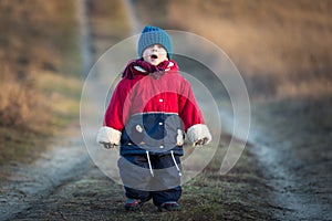 Young happy boy playing outdoor on country road