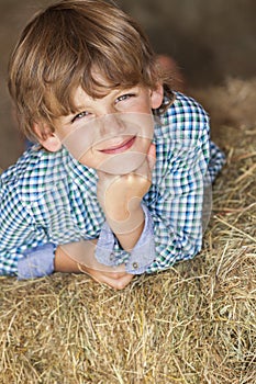 Young Happy Boy Smiling on Hay Bales