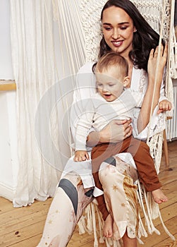 young happy brunette mother with little cute son at home having fun happy smiling, lifestyle people concept