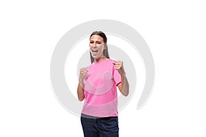 young happy brunette woman in pink basic t-shirt on white background with copy space