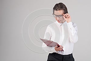 Young happy business girl looks at document isolated