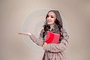 Young happy business woman holding her hand palm up