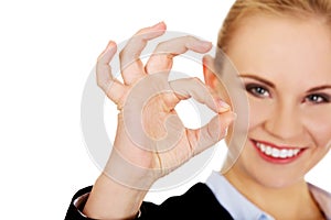 Young happy business woman shows OK sign