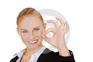 Young happy business woman shows OK sign