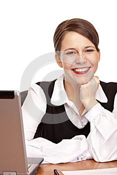 Young happy business woman sits on desk in office