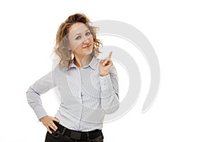 Young happy businesswoman with curly hair standing over white background smiling with happy face looking and pointing to the side