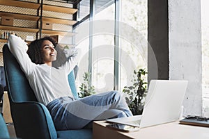 Young happy businesswoman relaxing at office lobby, Smiling woman working on laptop computer in modern office, successful business