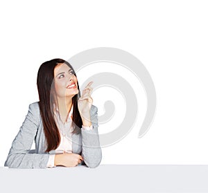 Young happy businesswoman sitting at the table