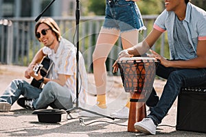 Young happy buskers performing and singing