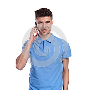 Young happy casual man speaks on the phone