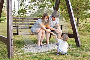 Young happy caucasian couple with baby boy. Parents and son having fun together. Mother and father play with toddler