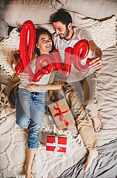 Young happy caucasian couple in bed