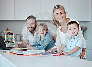 Young happy caucasian family having fun together at home. Loving parents helping their little children with homework