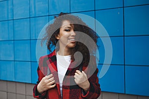 Young Happy Caucasian Girl Woman Dressed In Black Jacket Having Fun, Enjoying Life And Smiling In Street Of Minsk. Wind