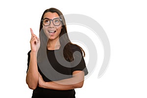 Young happy Caucasian woman smiling and pointing finger up havin