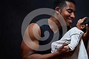 Young happy, cheerful man is playing with his baby girl