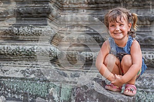 Young happy child girl, smiling portrait, Angkor wat, cambodia