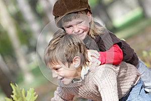 Young happy children on natural autumn backgrou