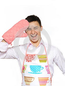 Young happy cook man in apron smiling