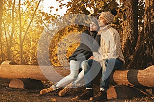 Young and happy couple in the autumn park