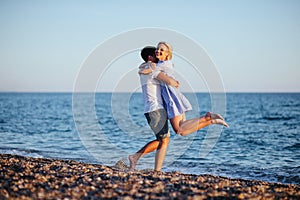 Young happy couple on beach at summer vacation