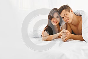 Young happy couple in bed