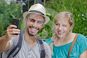 young happy couple doing selfie in nature