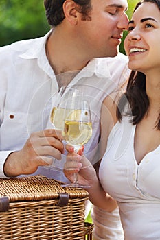 Young happy couple enjoying a glasses of white wine