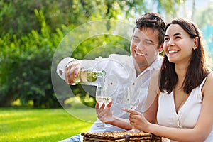 Young happy couple enjoying a glasses of white wine