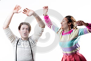 Young happy couple enjoying on plain background