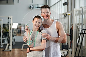 Young happy couple at gym.