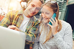 Young happy couple have lunch brake together, woman talking on the phone