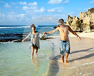 Young happy couple holding hands