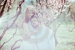 Young happy couple in love outdoors. loving man and woman on a walk at spring blooming park