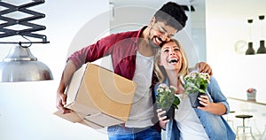 Young happy couple moving in new home and unpacking boxes