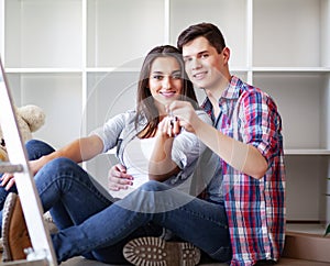 Young happy couple moving into their new home. They unpacking and cleaning new home