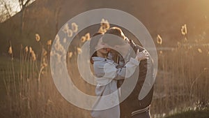 Young happy couple in the Park at sunset having fun and enjoy life. A loving couple meets together the sunset in a