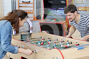Young happy couple playing table football