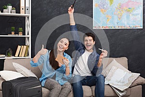 Happy couple preparing for vacation with passport