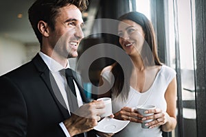 Young couple of professionals chatting during a coffee break