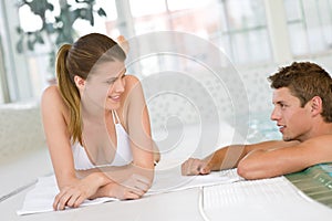 Young happy couple relax at swimming pool