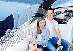 A young and happy couple relaxing on a boat