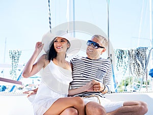 Young and happy couple relaxing on a vacation on a boat