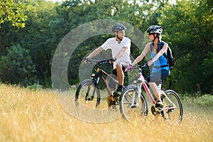 Young Happy Couple Riding Mountain Bikes Outdoor