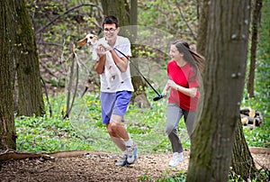 Young happy couple running with a dog