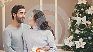 Young happy couple singing carols on Christmas Eve.