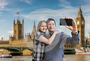 Young happy couple is taking selfie photo in London